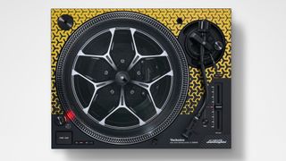 The Technics SL-1200M7B turntable in yellow with the bundled picture disc playing