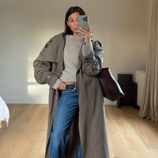 Marianne Smyth in a trench coat and jeans