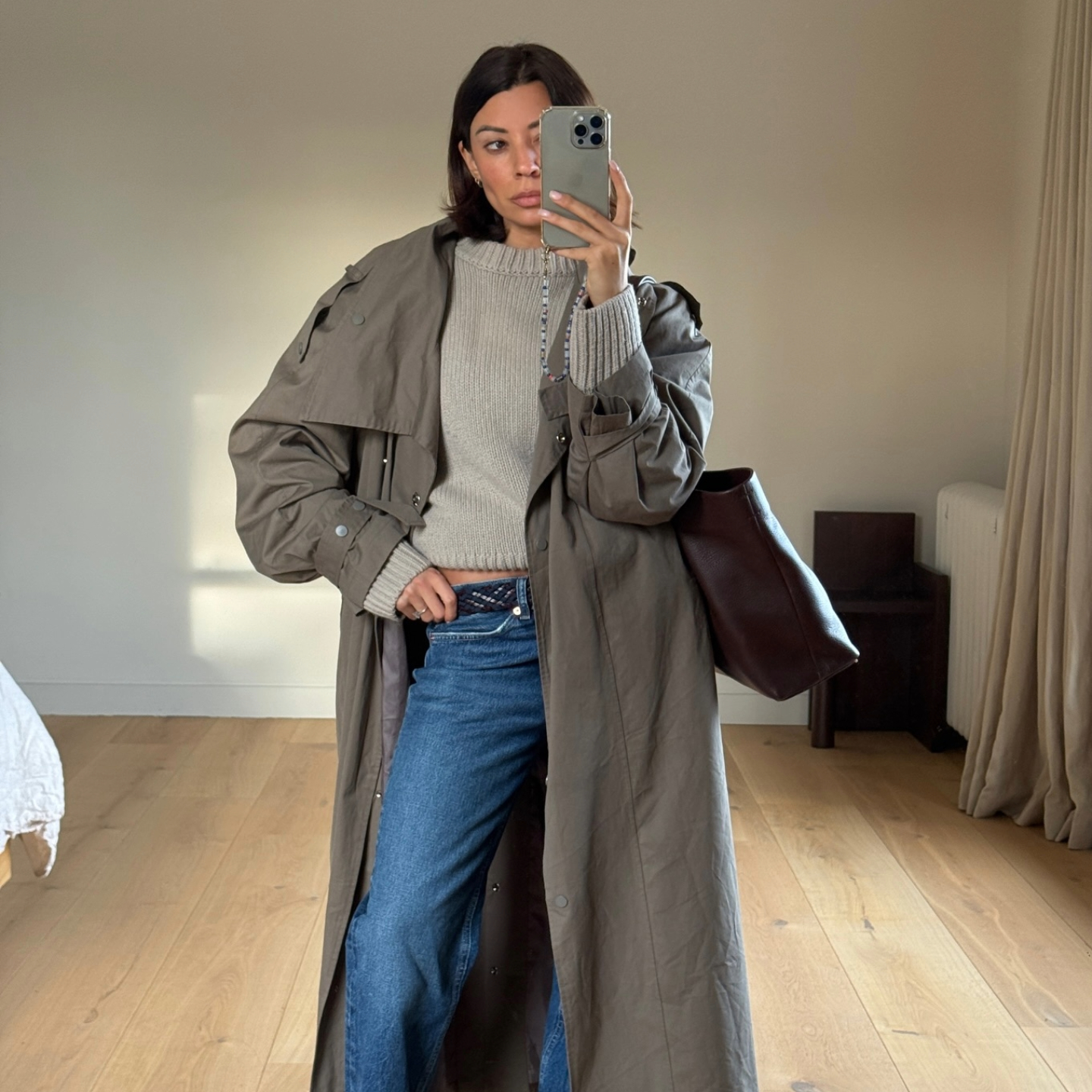 Marianne Smyth in a trench coat and jeans