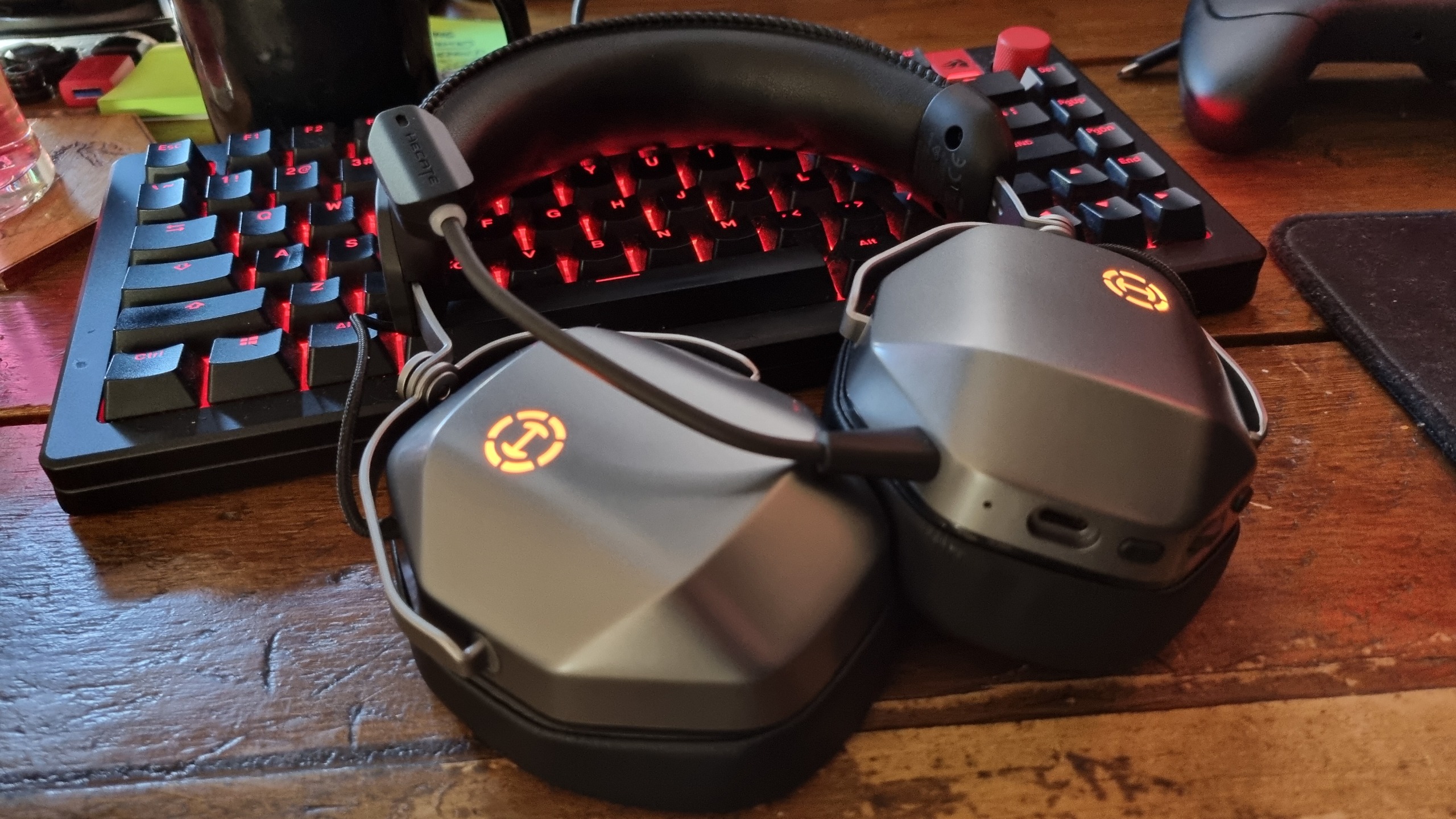 An Edifier G5 Max gaming headset on a desk, resting on an RGB-lit gaming keyboard