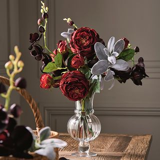 red rose flower vase on wooden table