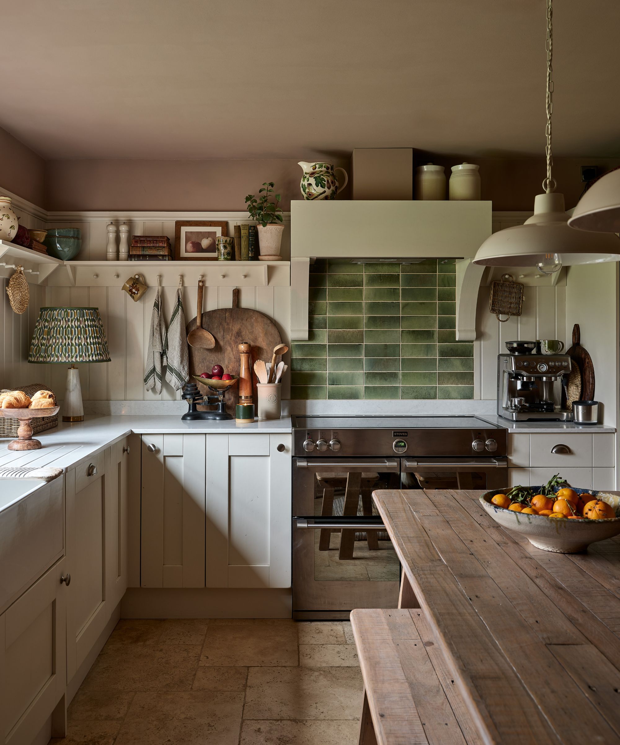 Green and white kitchen with a paneled backsplash