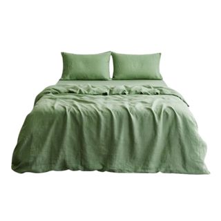 A pistachio green sheet set with two pillows on top of it