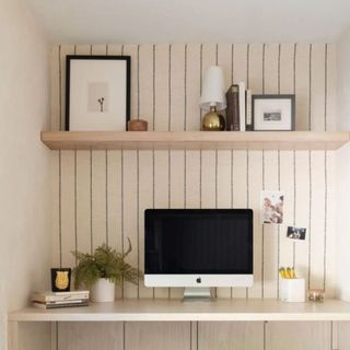White wall with desk and computer