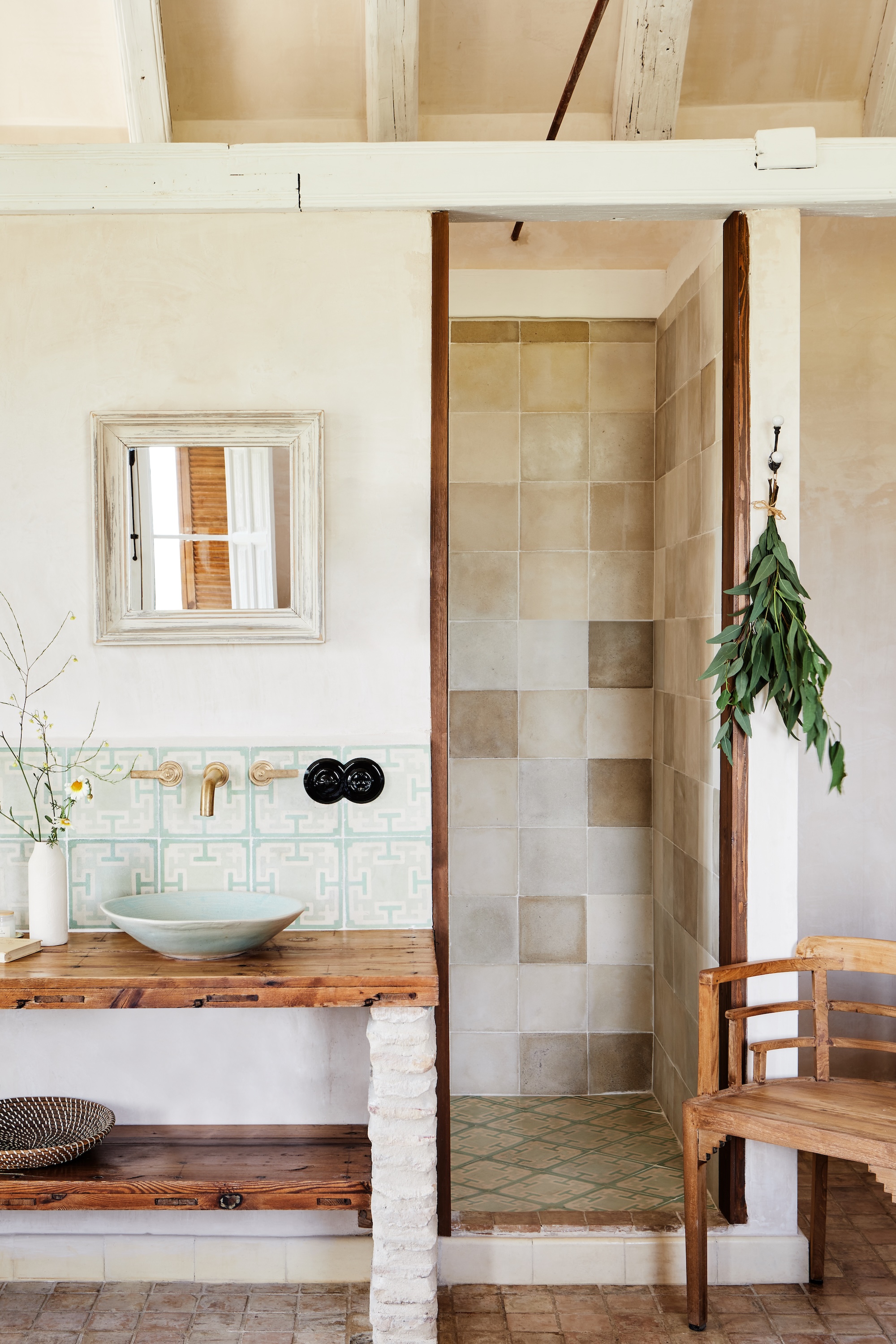 A neutral bathroom with natural materials and reclaimed tiles