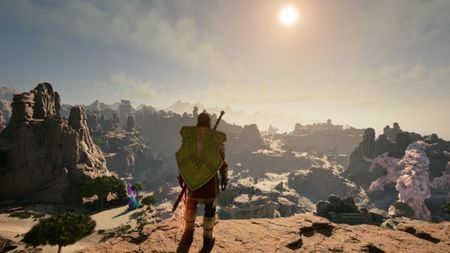 Avowed treasure maps - A scenic third-person shot of a character with a shield on his back looking out across a desert landscape.