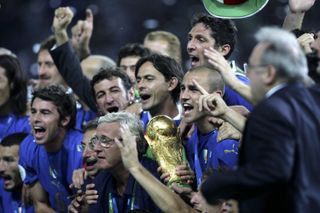 Italy players and coach Marcello Lippi celebrate with the trophy after their World Cup final win over France on penalties in July 2006.