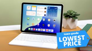 iPad Air M3 on Magic Keyboard sat on desk with plant pot in background with Tom's Guide Lowest Price badge