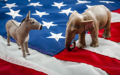 Democrats vs republicans are facing off in a ideological duel on the american flag. In American politics US parties are represented by either the democrat donkey or republican elephant