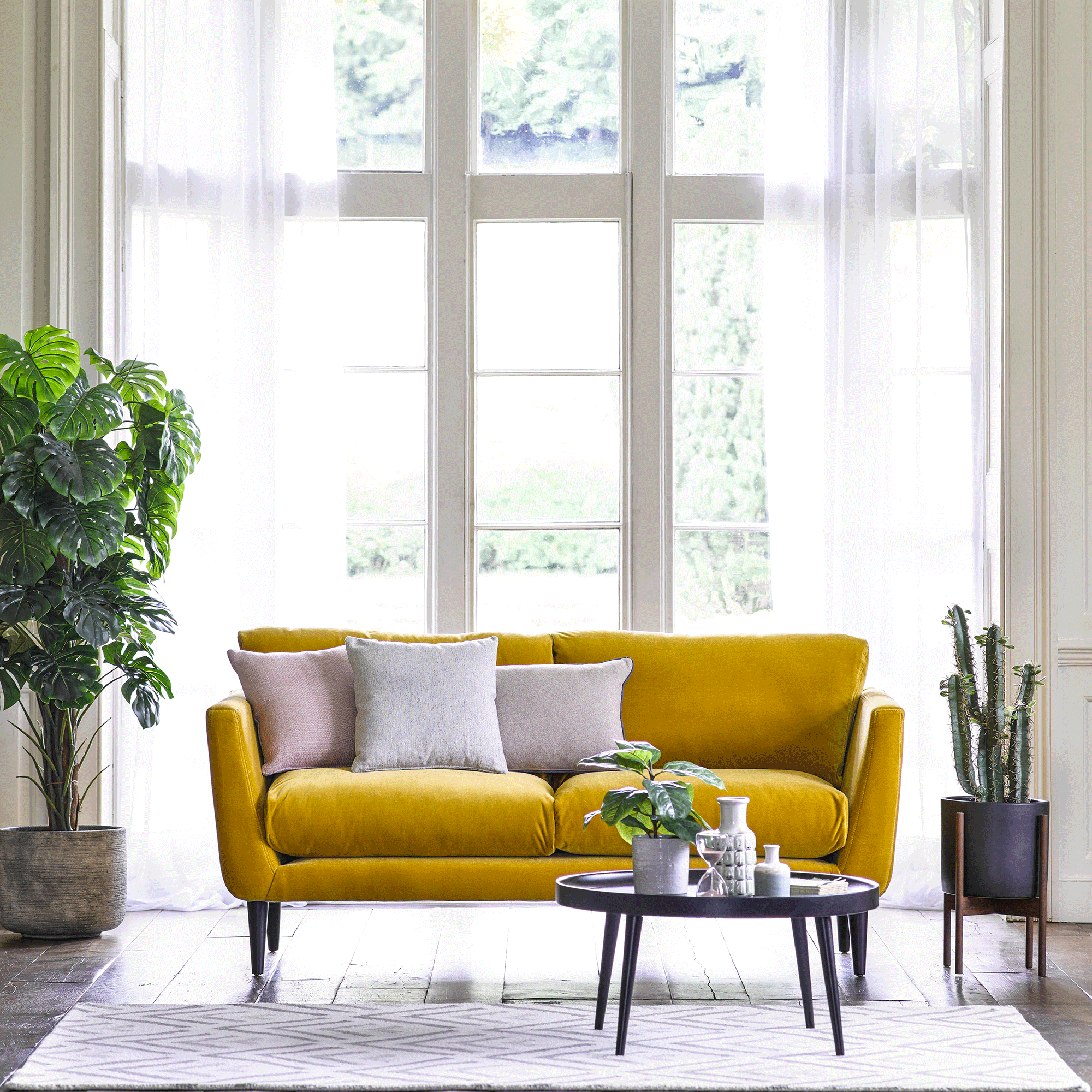 yellow sofa in white living room with windows