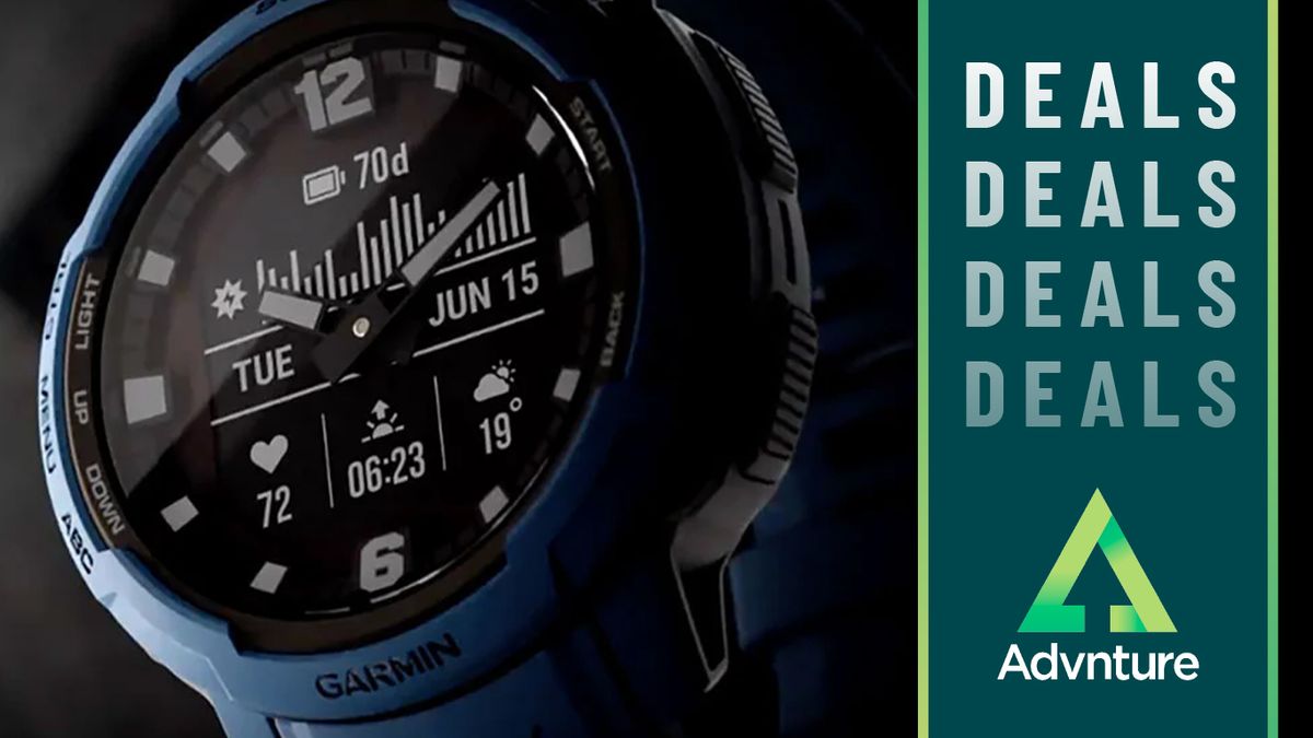 Close-up of Garmin Instinct Crossover Solar watch face against black background