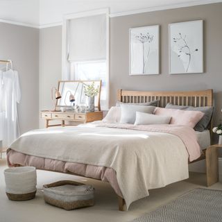 Grey bedroom with wooden bed and watercolour prints