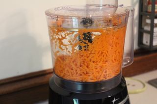 Shredded carrots in the Oster 10-Cup Food Processor with Easy-Touch