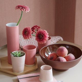room with peach colour cups and flower and fruits