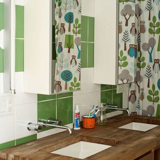 kids bathroom with white and green tiled walls
