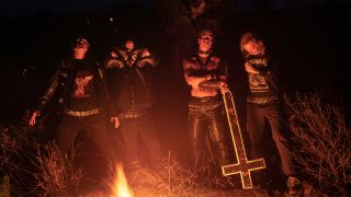 Desaster looking scary in the woods with a fire