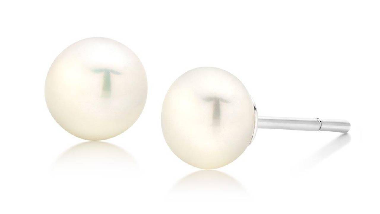 A pair of pearl earrings from Beaverbrooks on a white background.