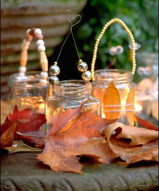glass jars used as decorative candleholders for fall displays