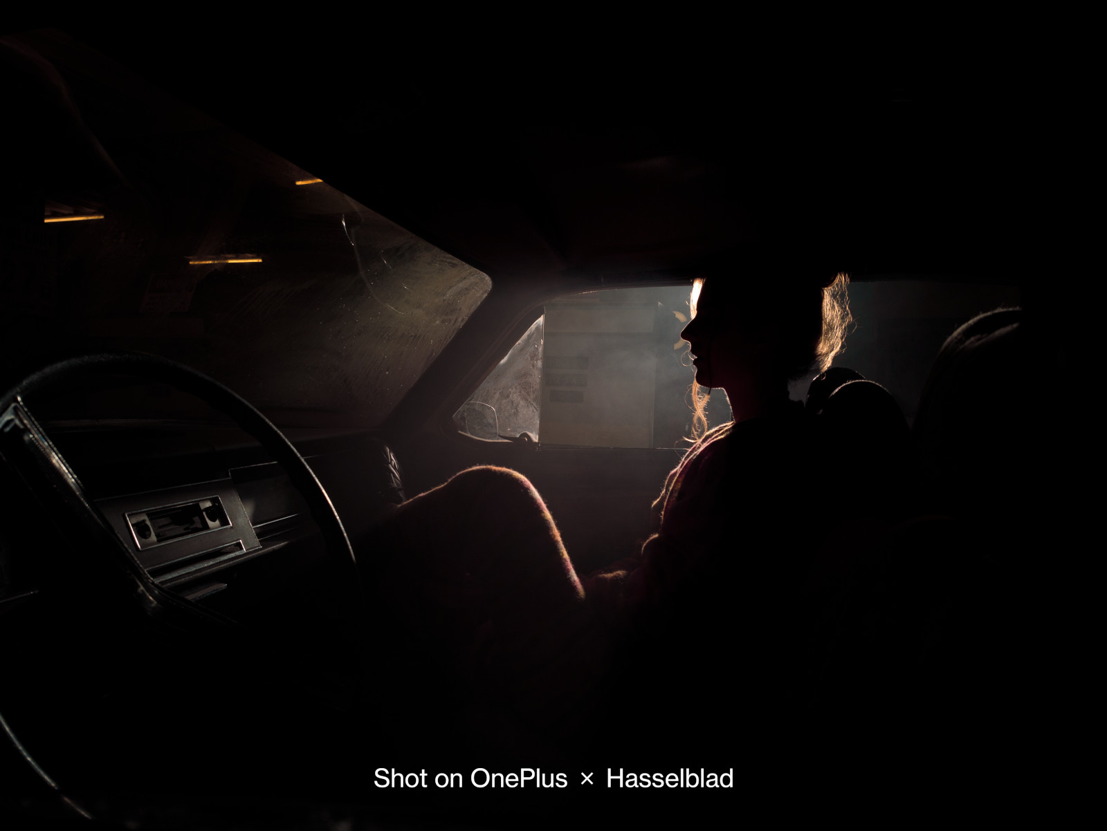 A OnePlus 10 Pro camera sample, showing an image of a woman sat in a car