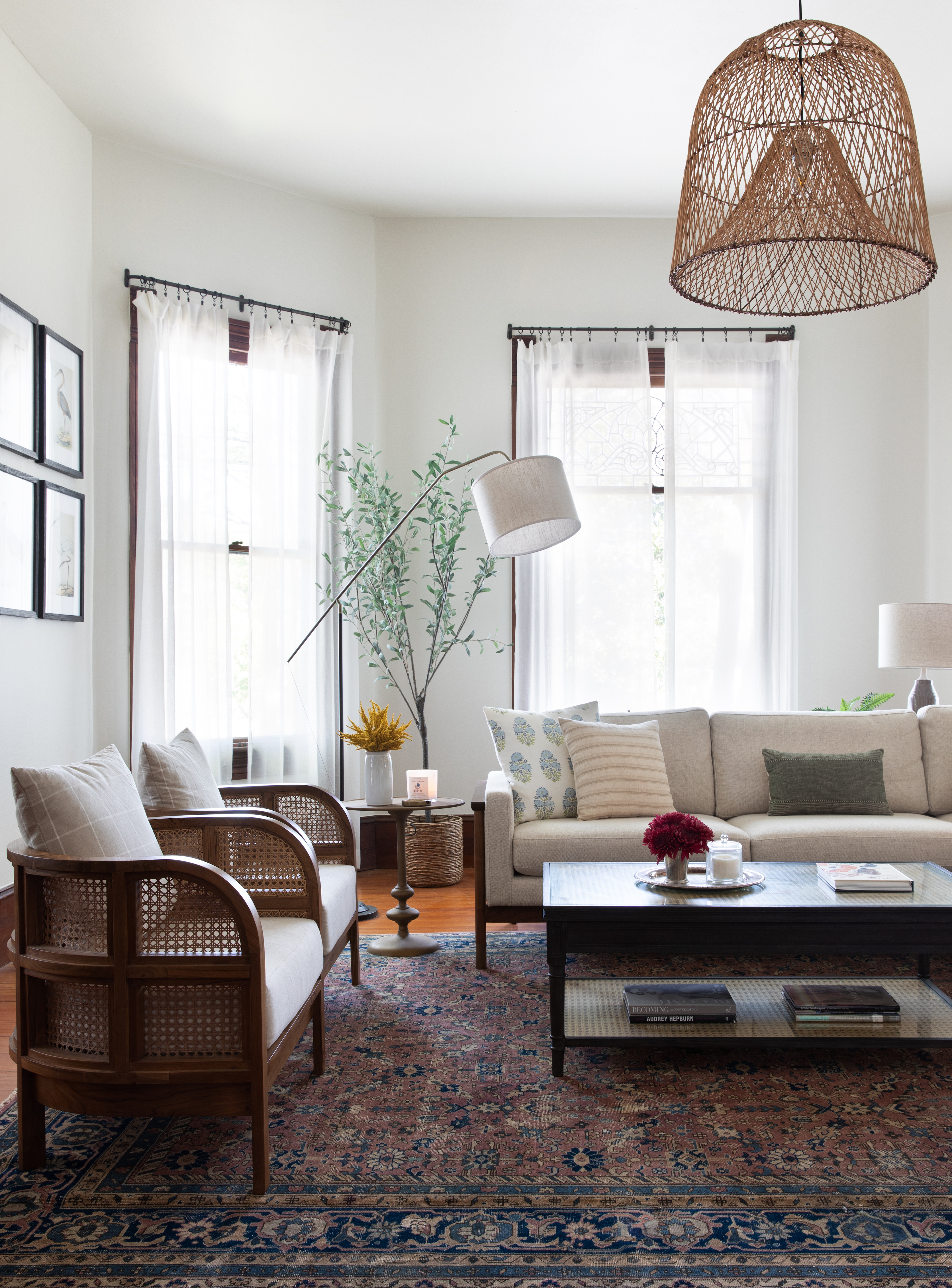 living room with sofa and armchairs and sheer curtains