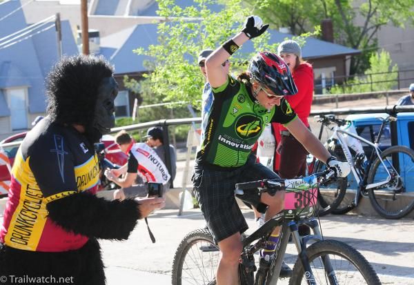 A gorilla hands up water to a rider