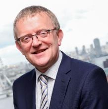 A headshot of Martyn Bridges who has glasses