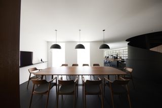 Interior of Naoto Fukasawa studio in Tokyo with long table and chairs by Maruni