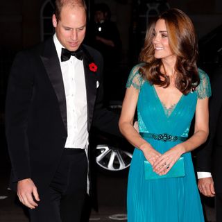 Prince William puts a hand on the small of Kate Middleton's back at a gala