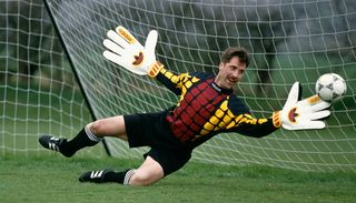 Arsenal goalkeeper David Seaman in action with oversized gloves during an Adidas coaching session circa 1993.