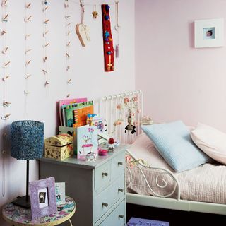 childrens bedroom with pink wall and grey cabinet