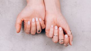 Hands with cream nail polish