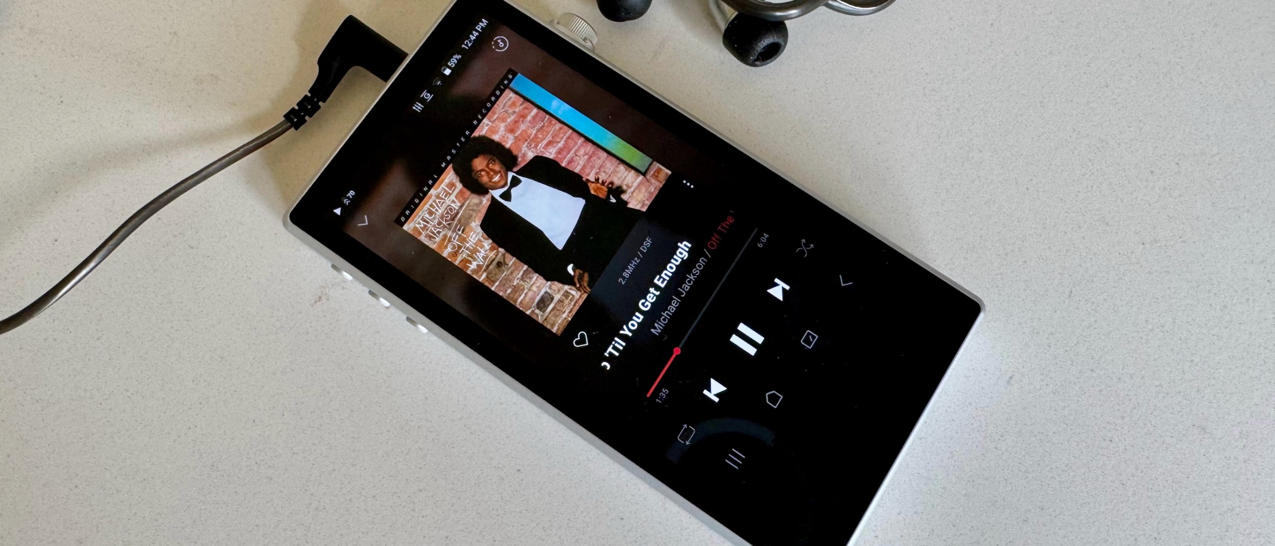 Astell &amp; Kern's PD5 player on a gray table, showing details of the player 