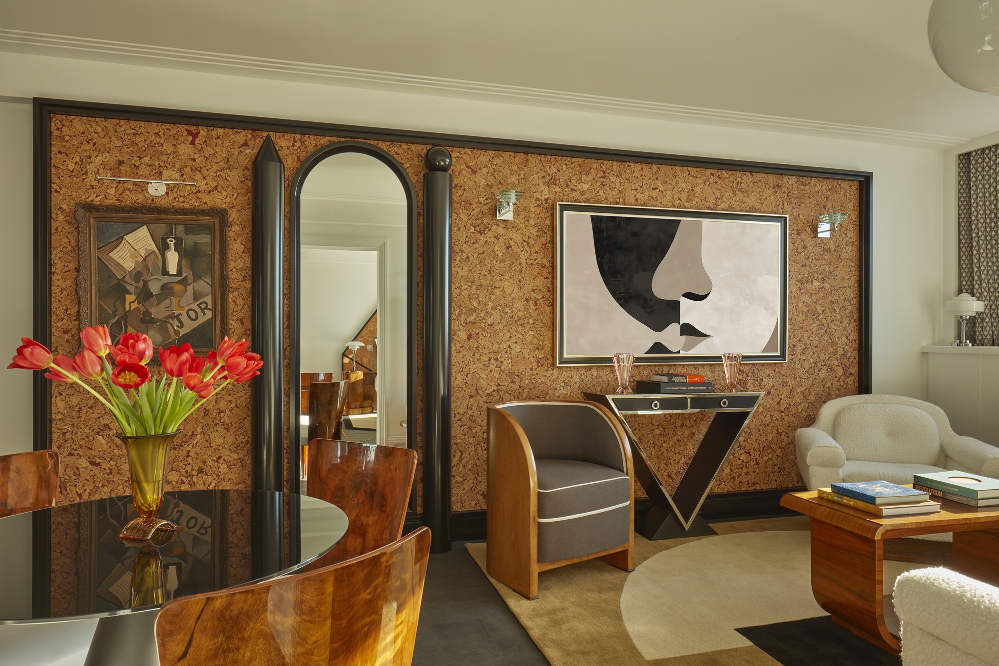 an art deco living room with a timber feature wall with a thick black trim around. the room has classic art deco furniture