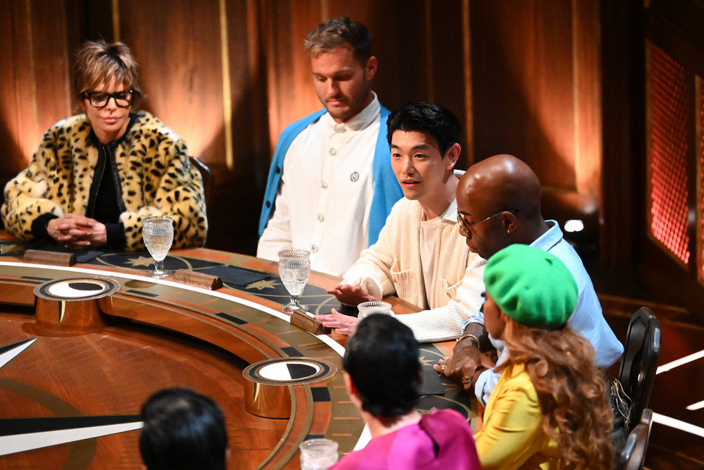 A group of people (clockwise Lisa Rinna, Colton Underwood, Eric Nam, Mon&amp;eacute;t X Change, Candice Dillard Bassett, and Johnny Weir) sit at the Round Table, in episode 404 of 'The Traitors.'