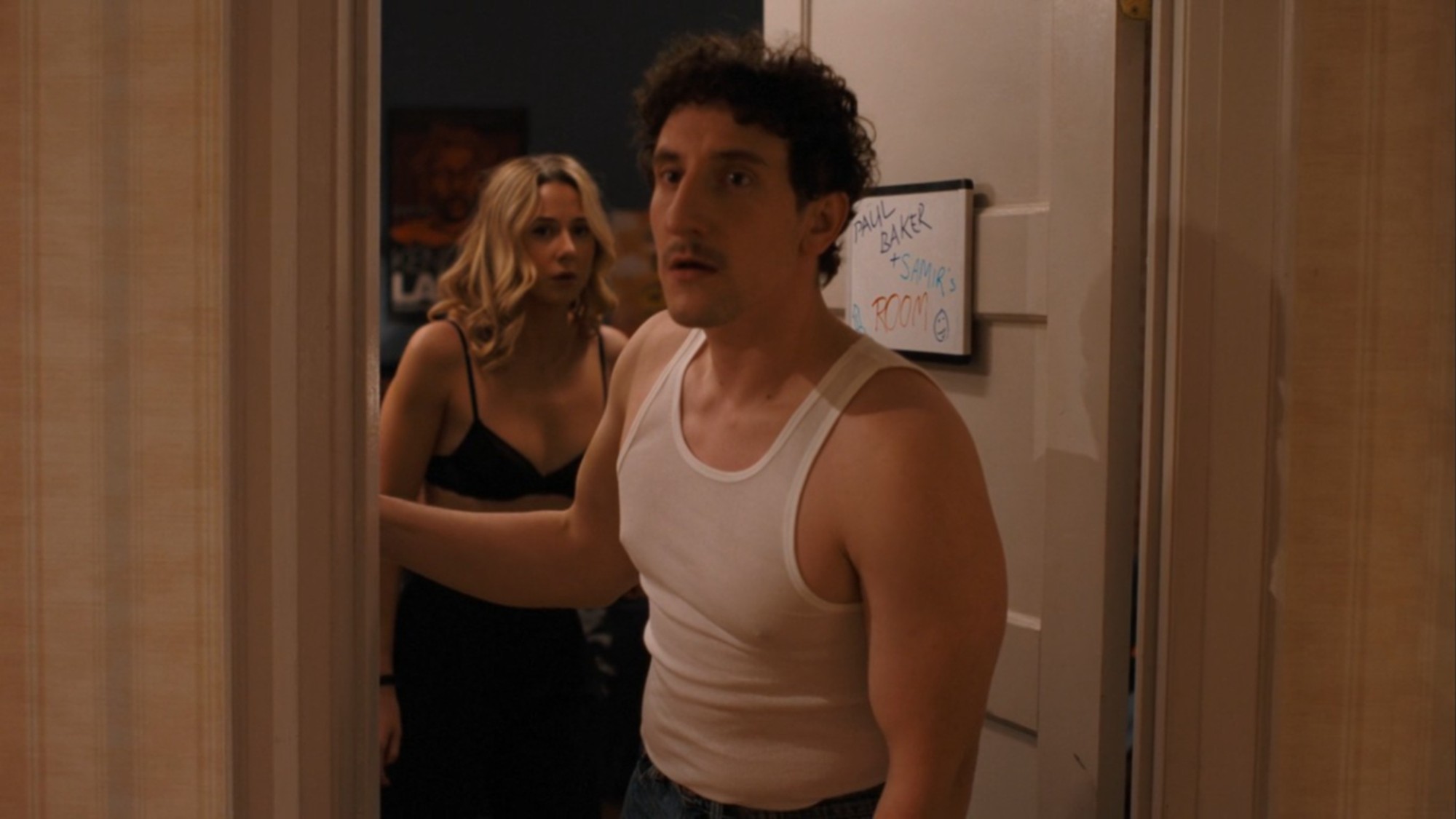 Lucy Freyer and Malik Elassal looking out the door in Adults Season 2.
