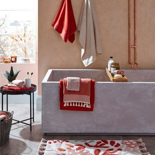 bathroom with floral bath mat and towel