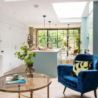 white kicthen with worktop and blue armchair