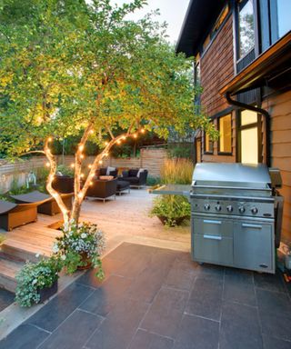 An outdoor bbq area on a patio in a residential backyard
