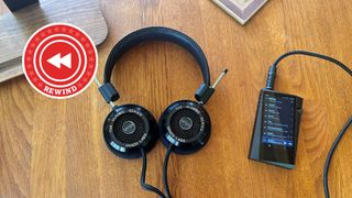 Grado headphones and player on desk with Rewind logo