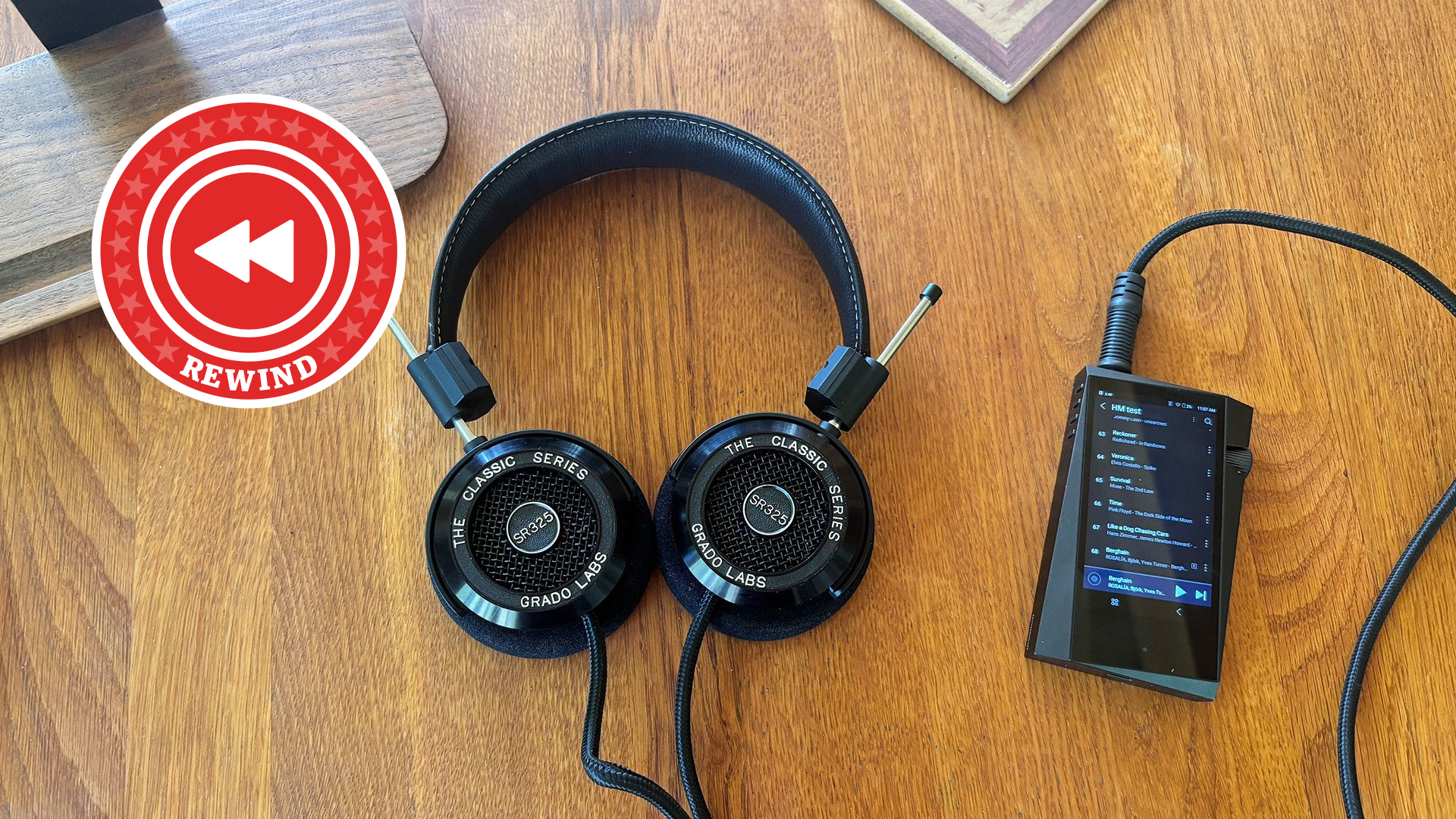 Grado headphones and player on desk with Rewind logo