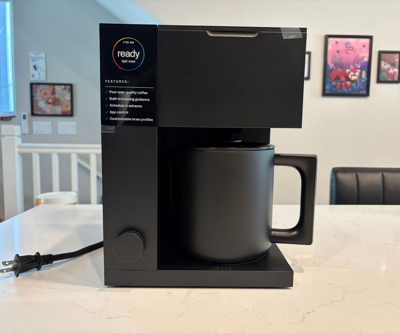 A block black coffee maker with a matching pitcher on a white kitchen counter.