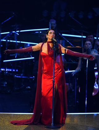 A photo of Dua Lipa wearing a crimson corset dress