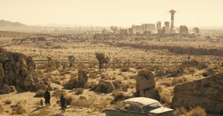 A screenshot from the Fallout season 2 trailer showing two characters on the outskirts of New Vegas