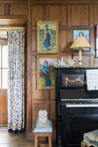 piano in Jacobean manor house with oak panels and sculptures