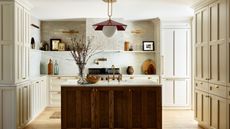 modern rustic kitchen with wooden island, warm neutral cabinets and walls