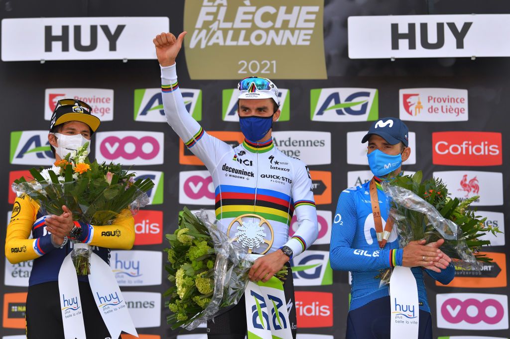 MUR DE HUY BELGIUM APRIL 21 Podium Primoz Roglic of Slovenia and Team Jumbo Visma in 2nd place Julian Alaphilippe of France and Team Deceuninck QuickStep in 1st place Alejandro Valverde Belmonte of Spain and Movistar Team in 3rd place celebrates during the 85th La Fleche Wallonne 2021 Men Elite a 1936km race from Charleroi to Mur de Huy 204m Mask Covid safety measures Flowers Medals FlecheWallonne on April 21 2021 in Mur de Huy Belgium Photo by Luc ClaessenGetty Images