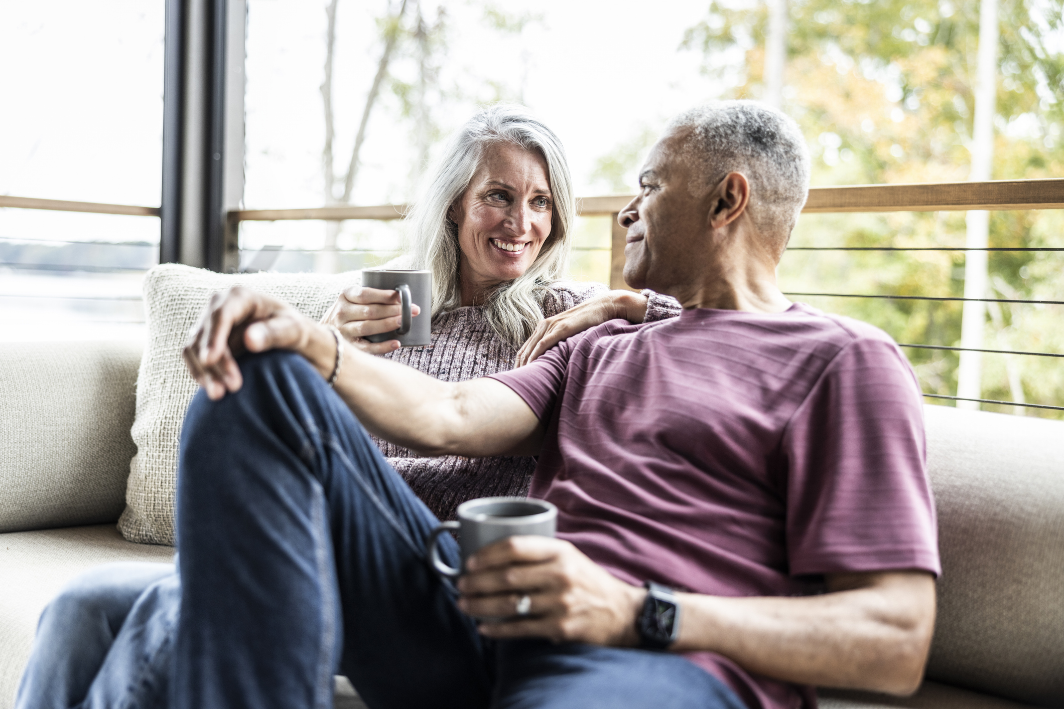 Pensioner couple discussing their pension on a sofa