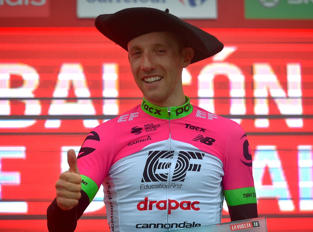 Michael Woods in a traditional Basque hat after winning stage 17 at the Vuelta