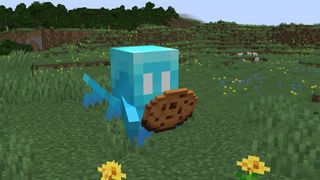 Minecraft Allay - Eine kleine blaue Kreatur mit Flügeln, hält einen Keks und fliegt durch die Luft