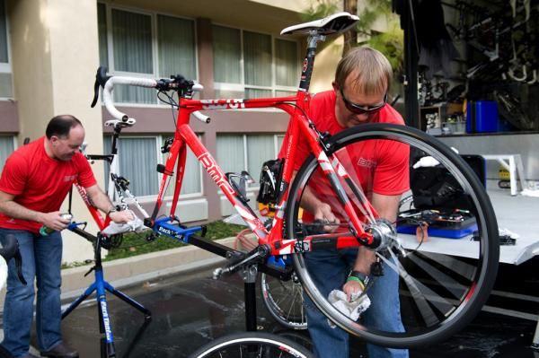 Team mechanic Andy Stone cleans a chain after the ride.